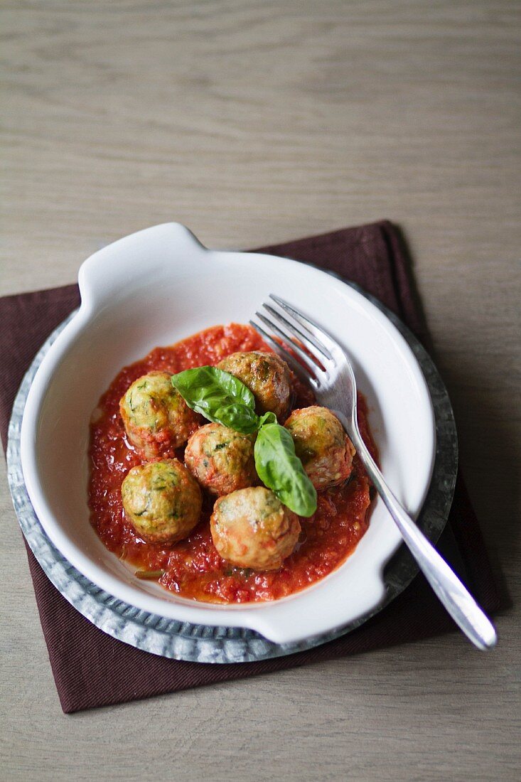 Veggie balls made from cream cheese and courgette in tomato sauce