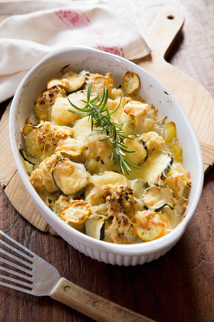 Cauliflower and courgette bake with cheese and rosemary