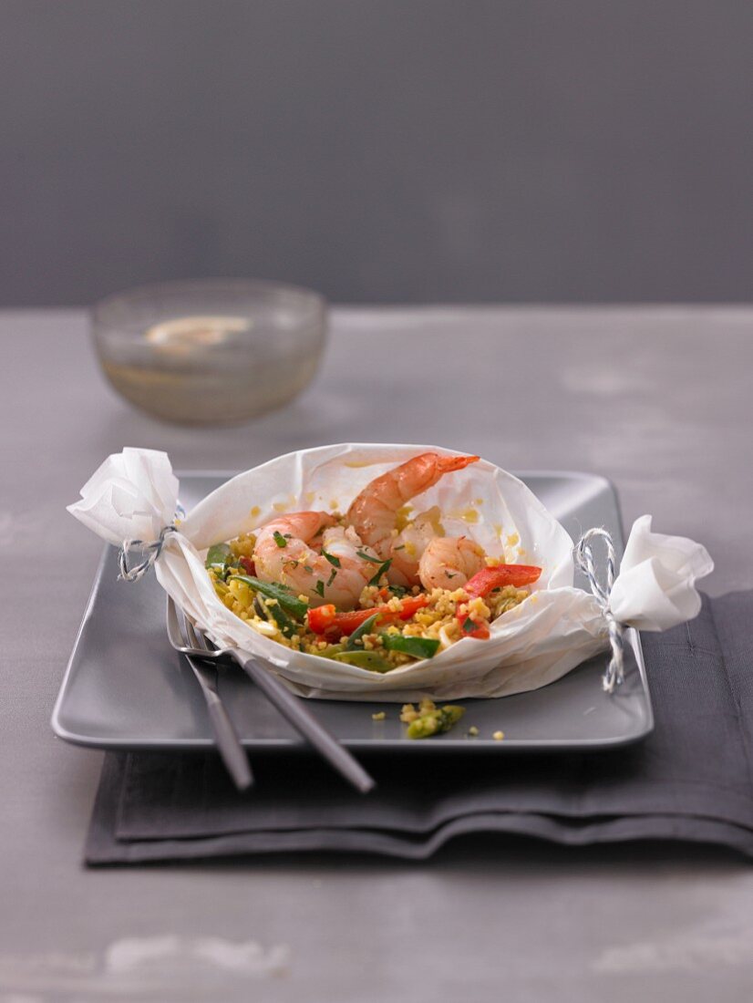 Couscous with prawns in a parchment paper