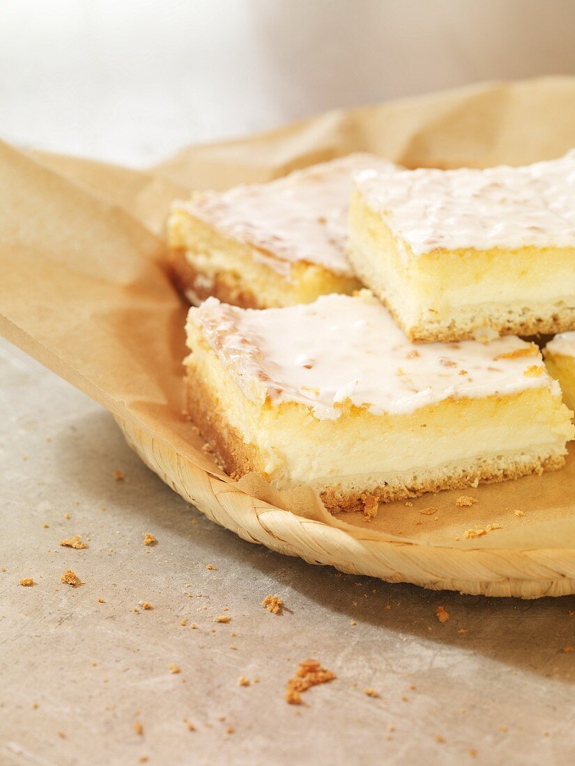 Four slices of coconut and quark cake on a piece of baking paper