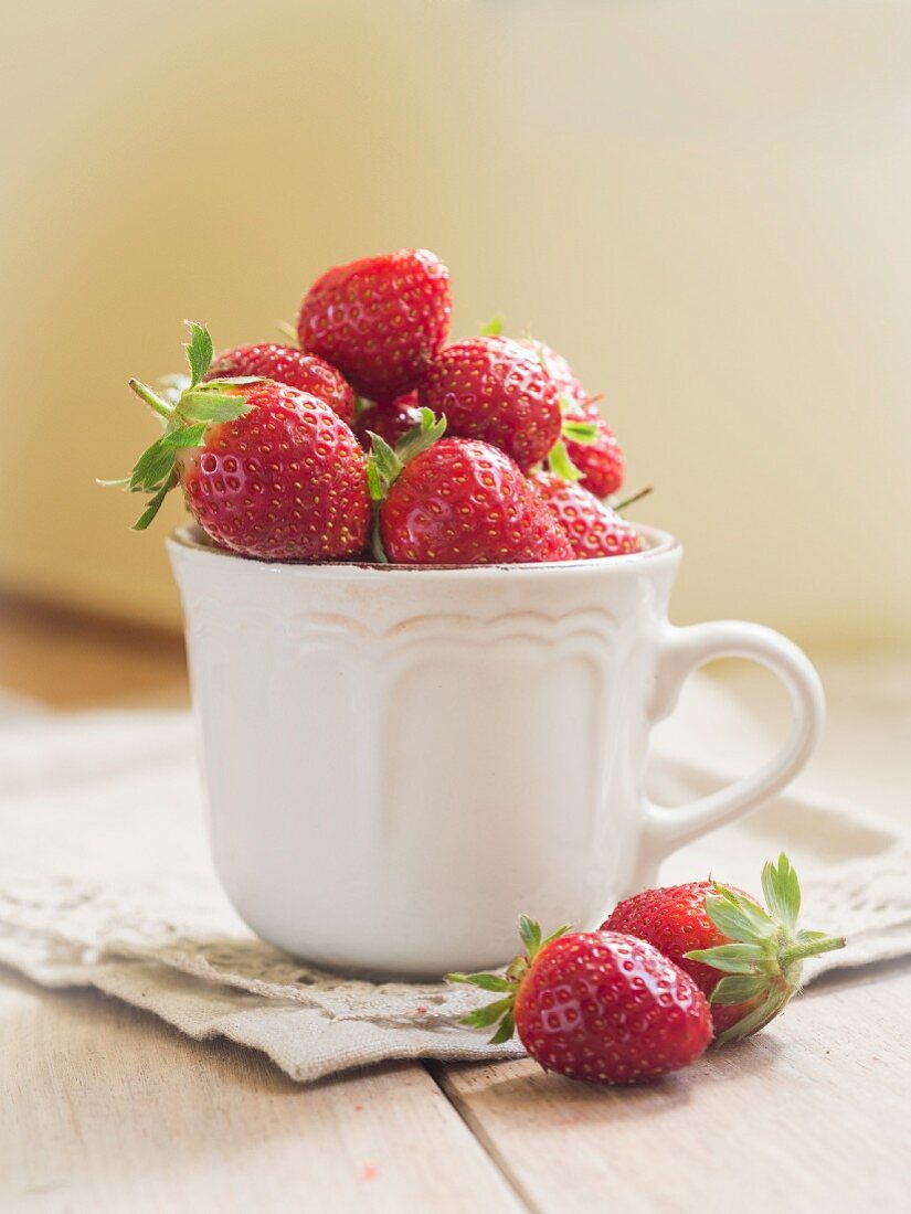 Fresh strawberries in a white cup