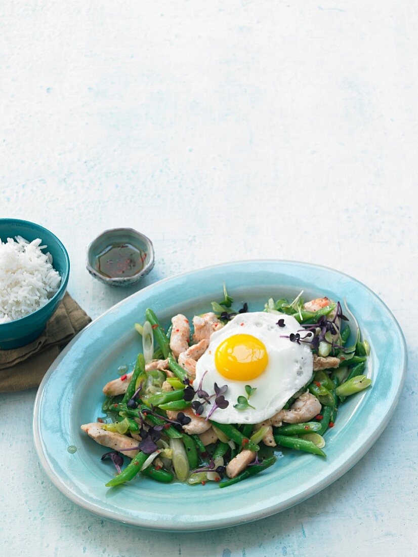Stir-fried chicken with a fried egg