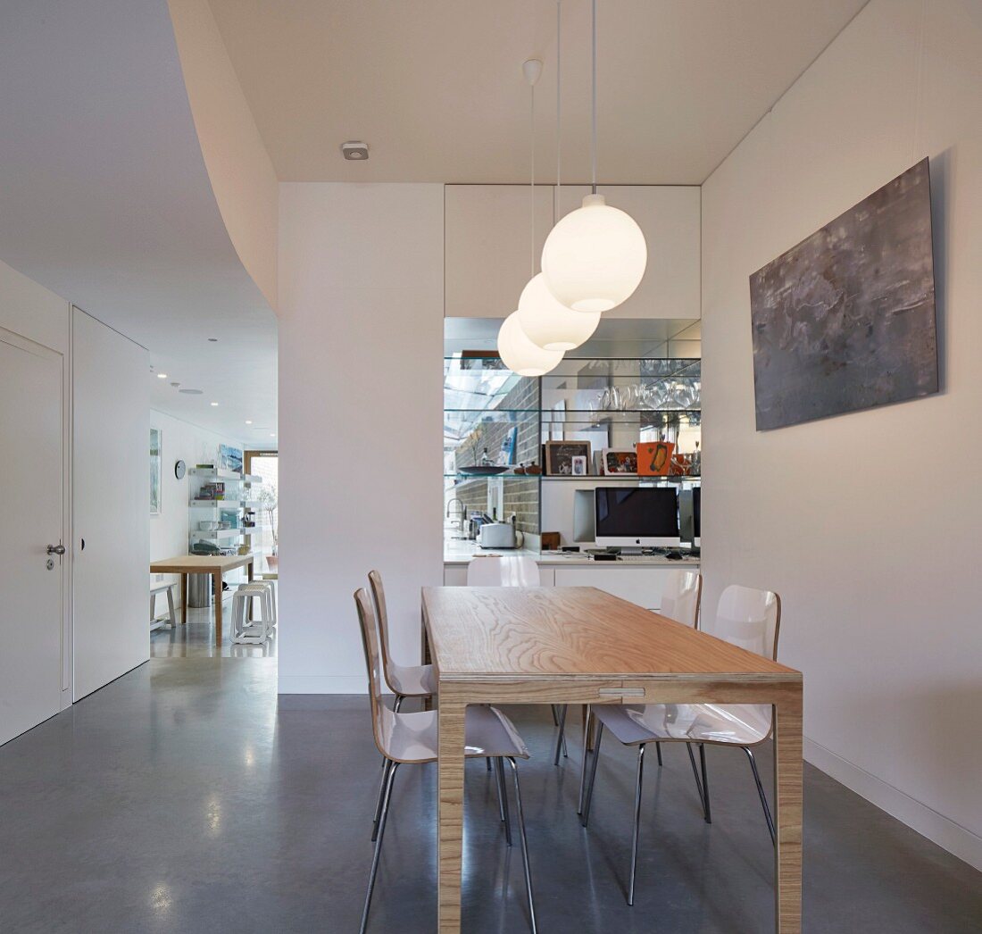 Modern dining area with view into kitchen