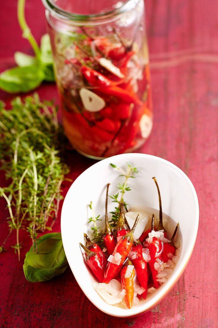 Preserved chilli peppers with herbs