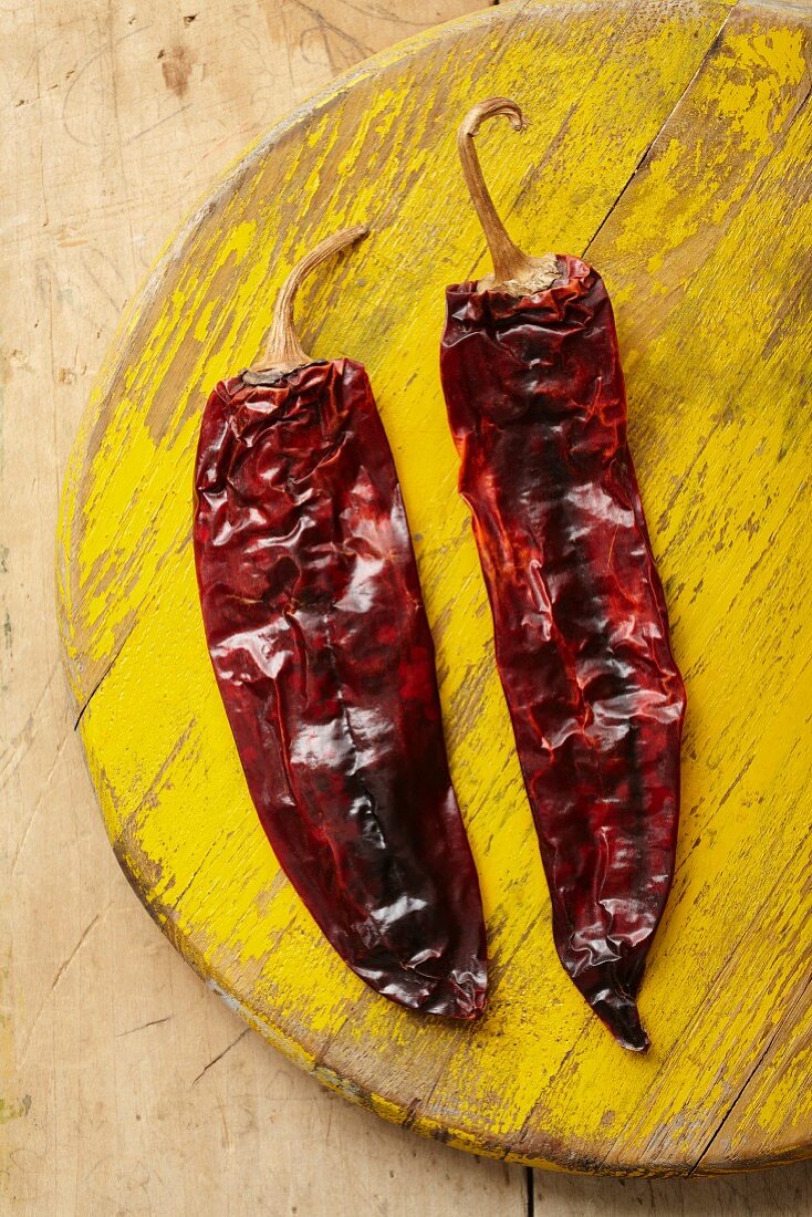 Two dried Guajillo chilli peppers (seen from above)