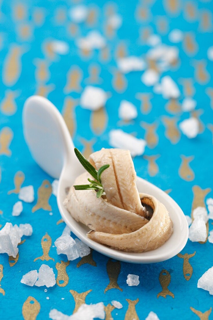 An anchovy fillet in oil as a spoon canapé