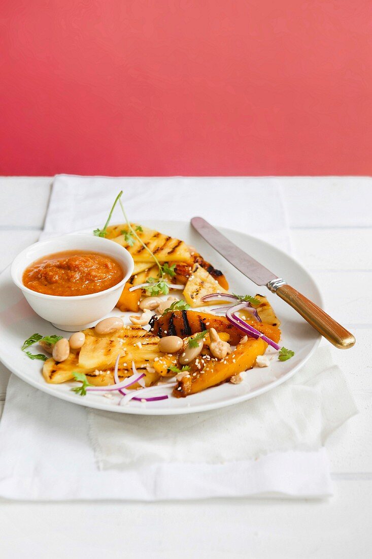 A salad featuring grilled pineapple and mango with a masala dressing