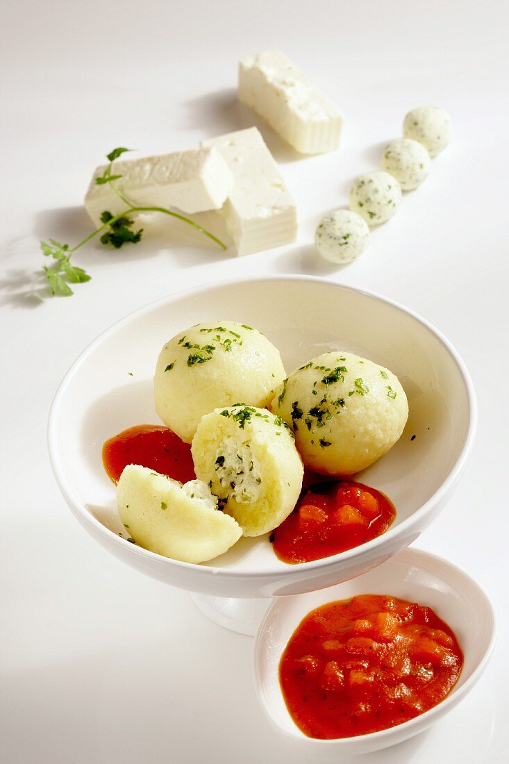 Potato dumplings filled with feta cheese and tomato sauce