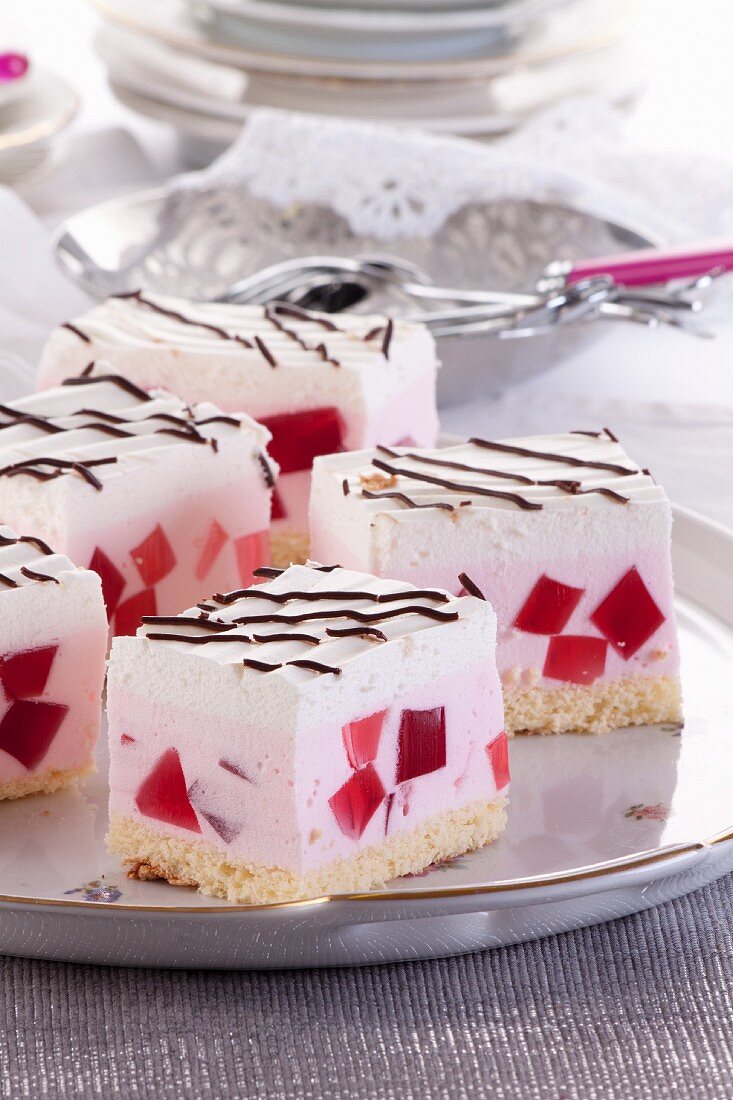 Cream slices with red jelly cubes