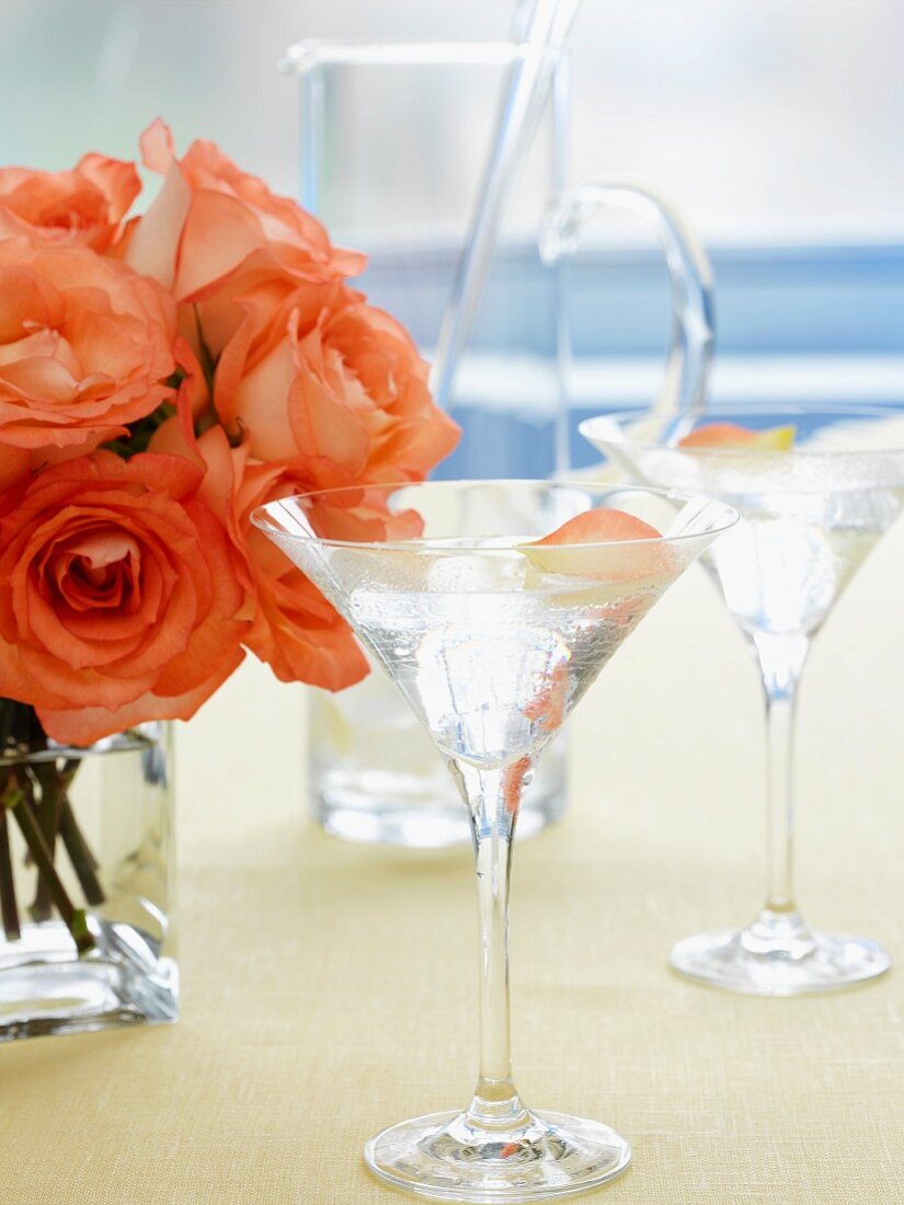 A rose Martini with a bunch of salmon-pink roses