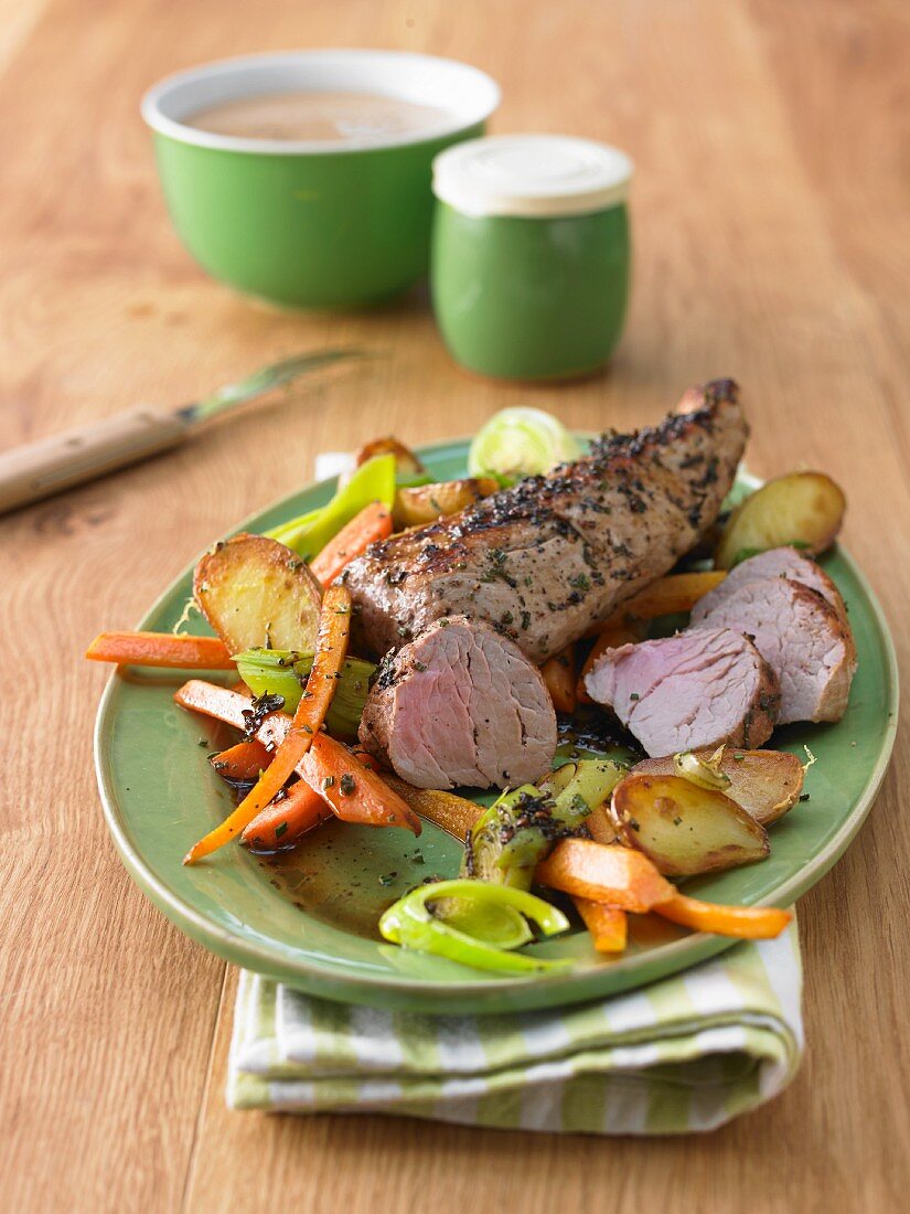 Roast pork fillet with potatoes, carrots and leek