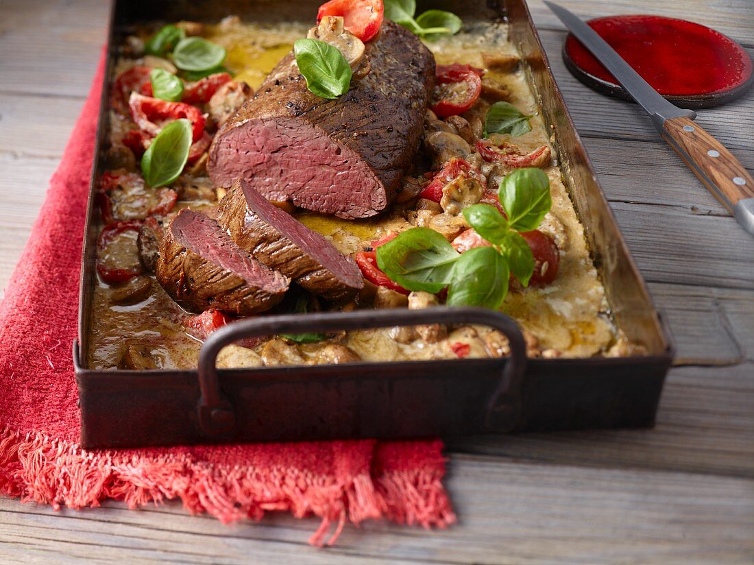 Oven-baked beef fillet with mushrooms and tomatoes