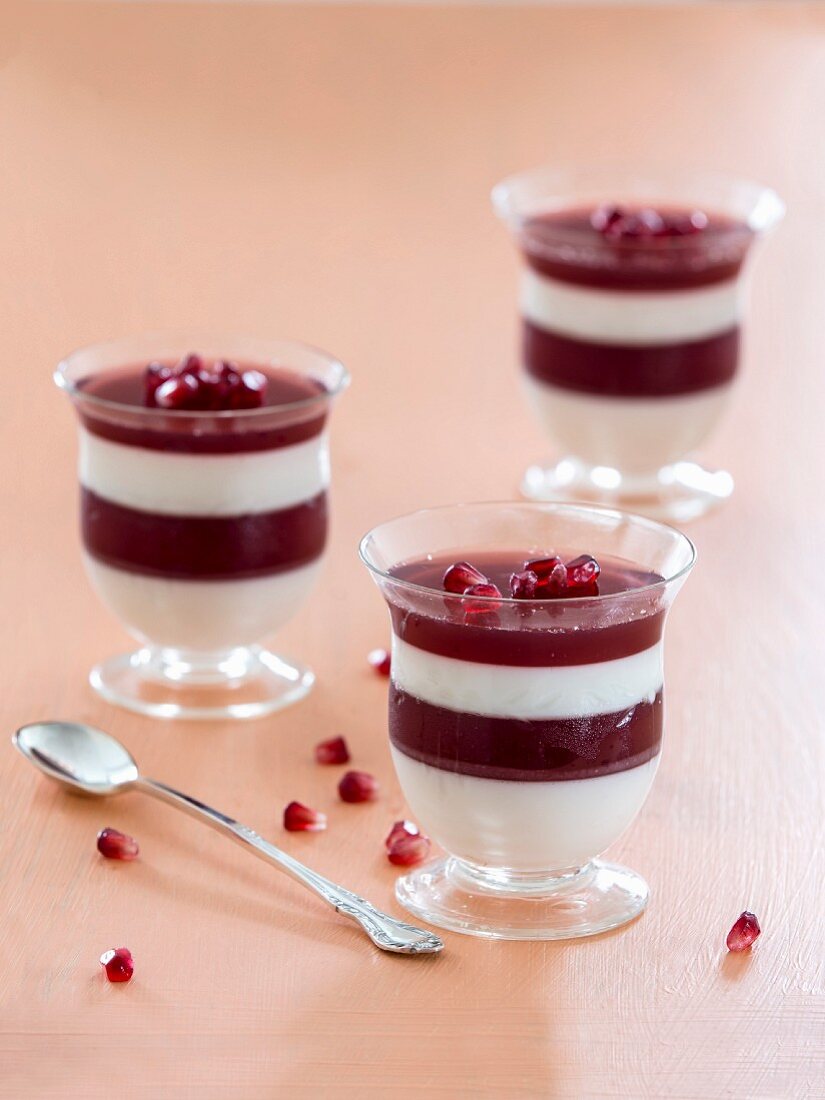 Layered desserts with coconut cream and pomegranate jelly