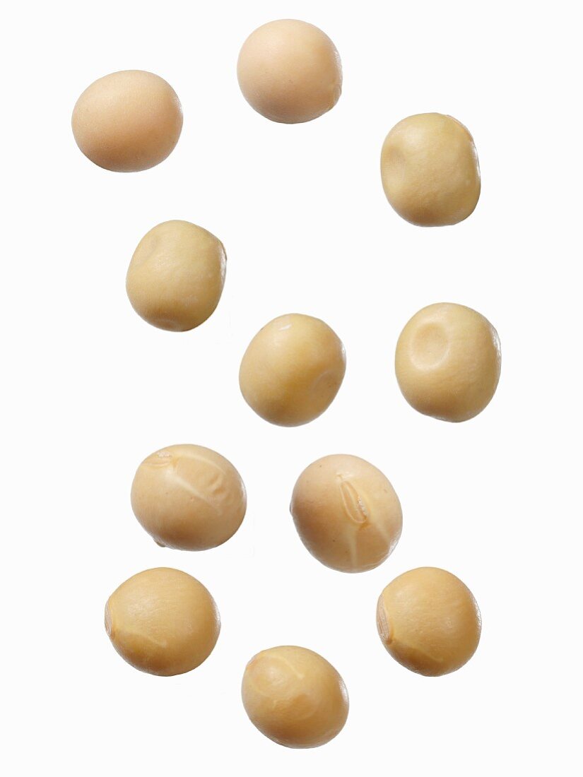 Soya beans on a white surface