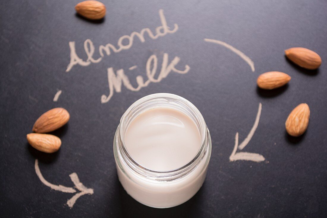 Almond milk in a screw-top jar on a blackboard