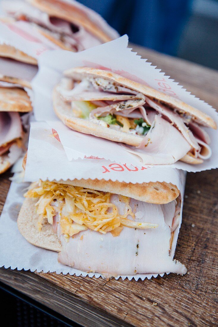 Various flatbread sandwiches wrapped in paper