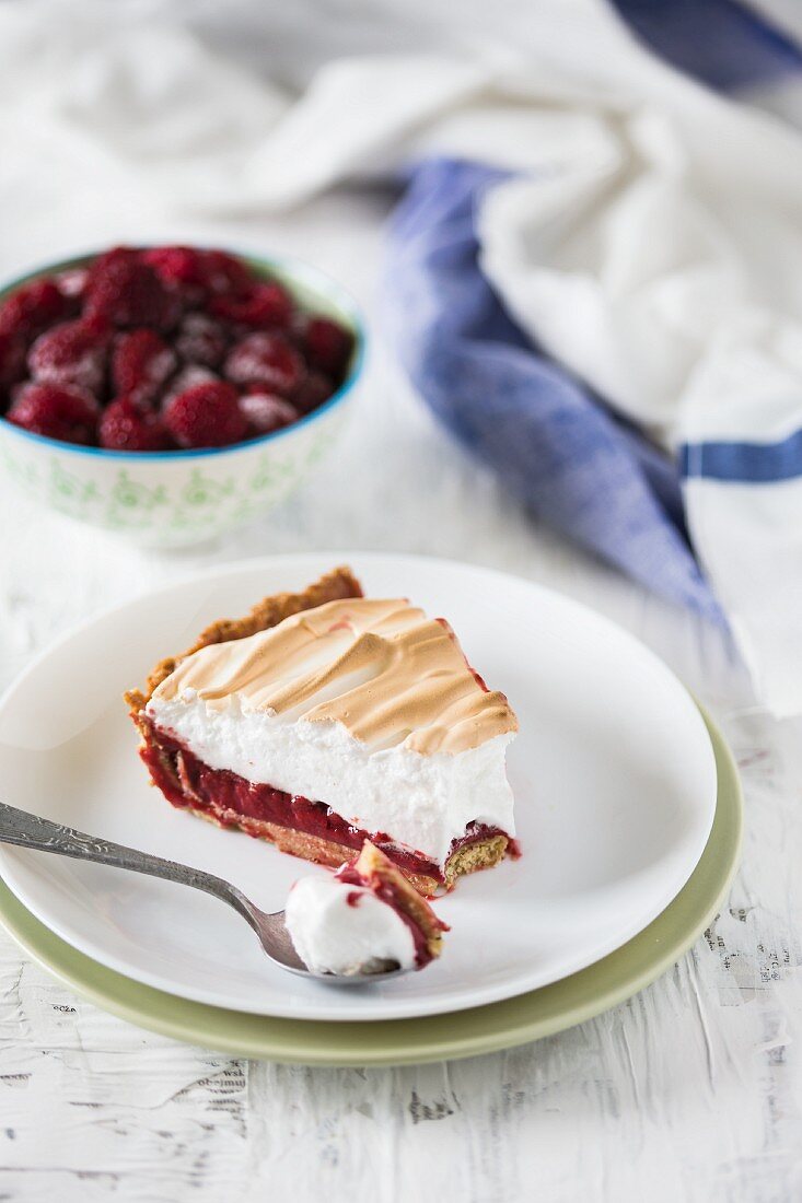 A slice of raspberry meringue tart