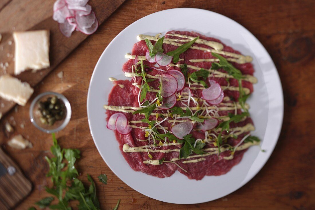 Beef carpaccio with radishes and rocket