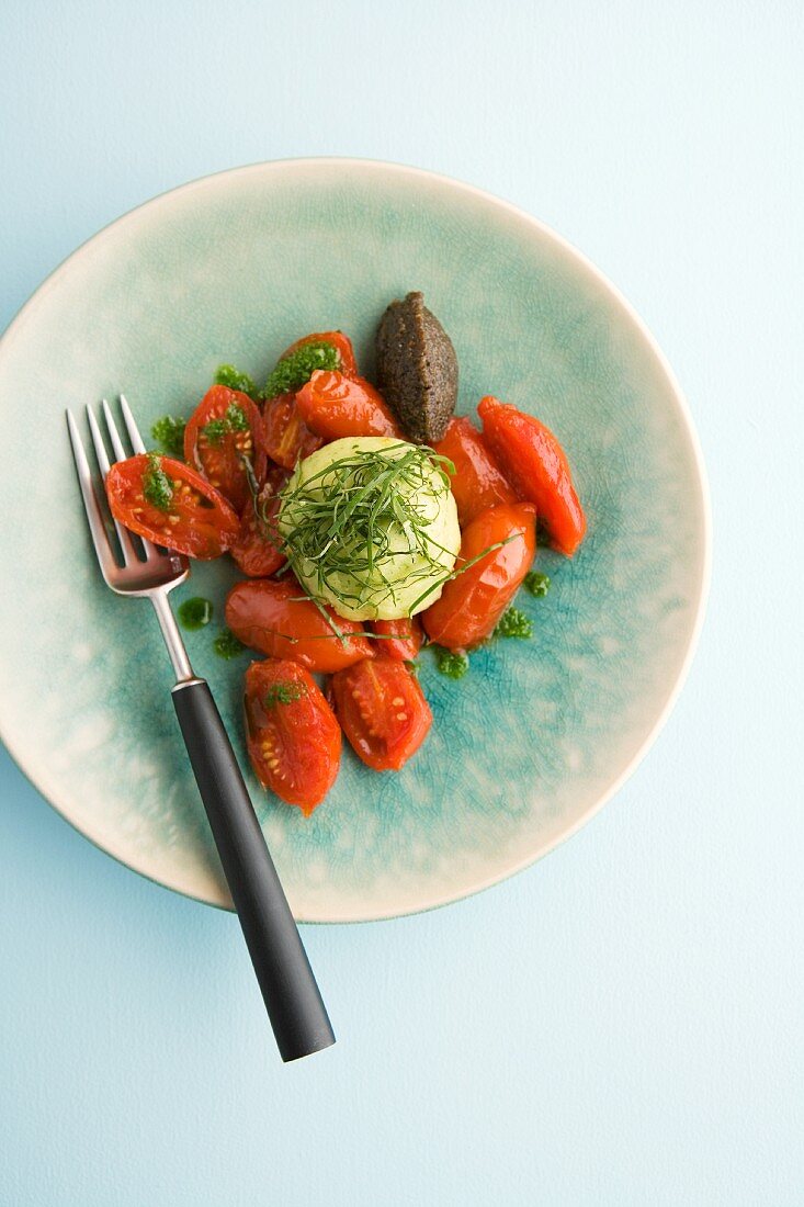 A Gorgonzola dumpling with basil on tomato compote with olive chutney