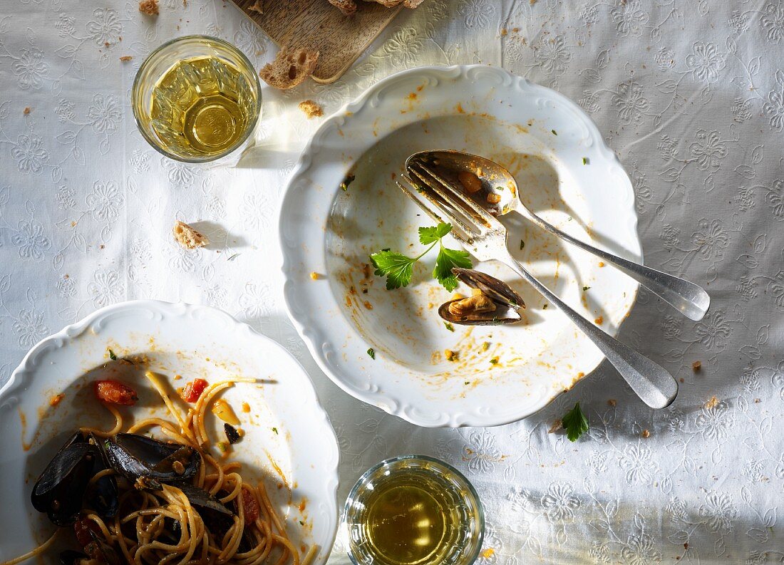 A plate with the remains of spaghetti and mussels