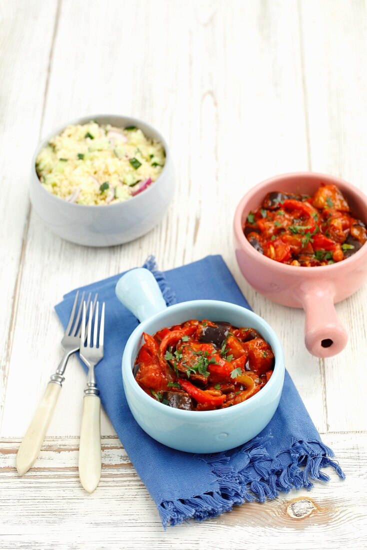 Aubergines and peppers with raisins braised in a tomato sauce served with couscous