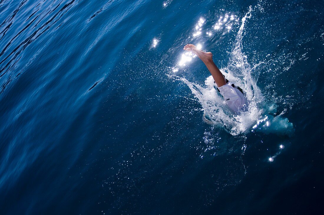 Mann springt ins Wasser