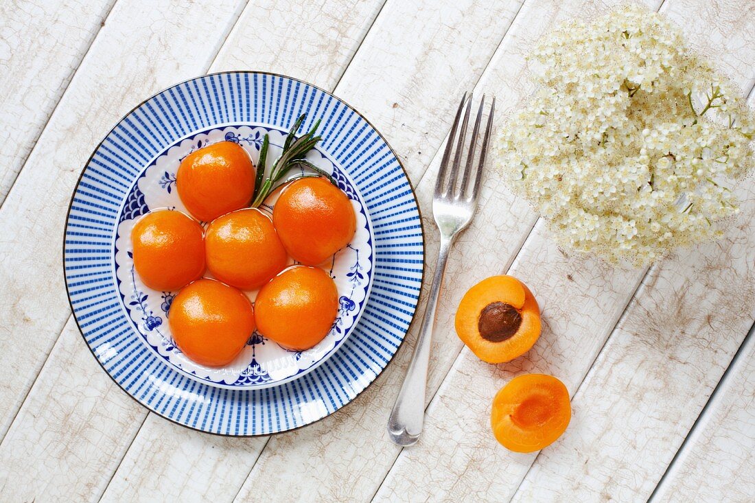 Poached apricots garnished with rosemary