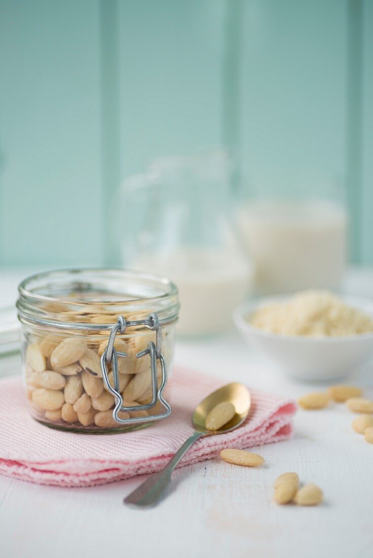 A jar of shelled almonds and a jug of almond milk