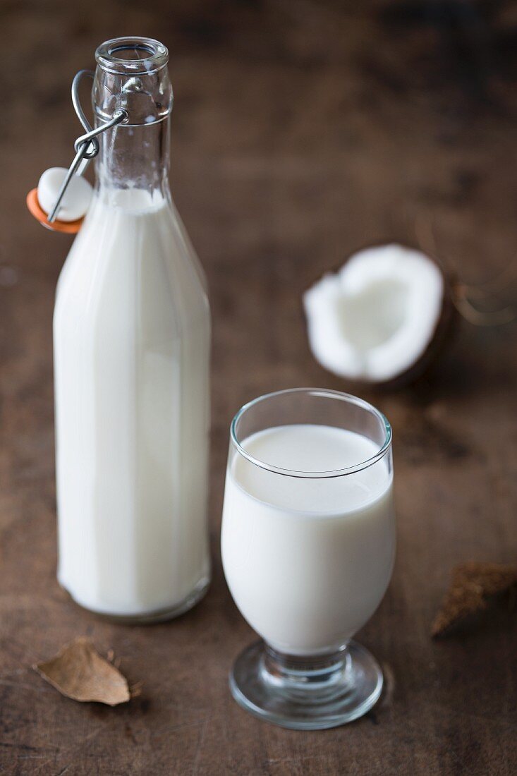 Coconut milk in a glass and in a bottle