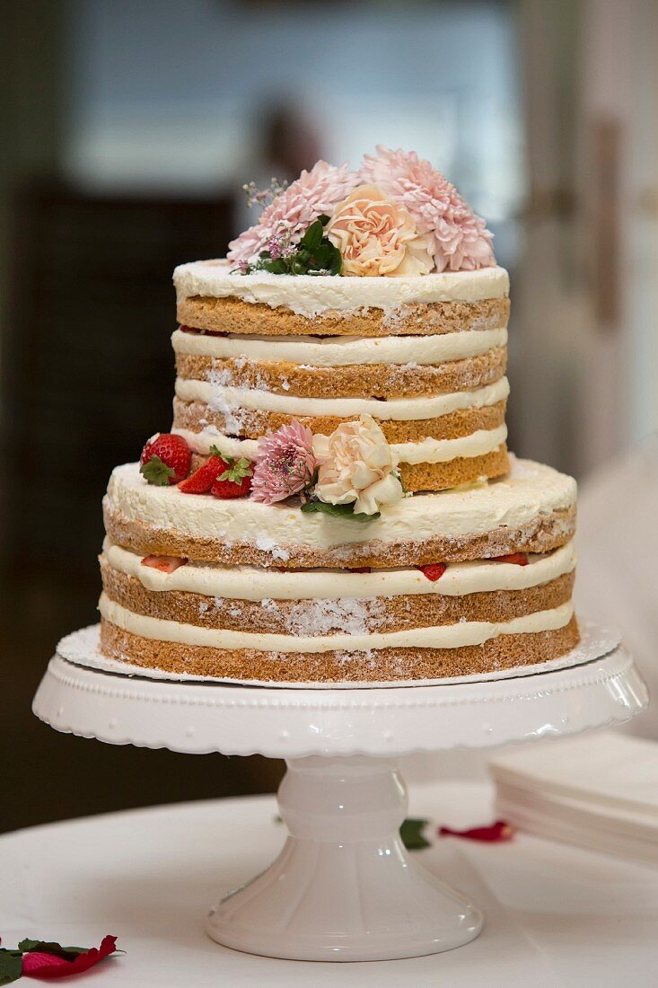 Naked cake – a layered wedding cake with mascarpone cream and strawberries