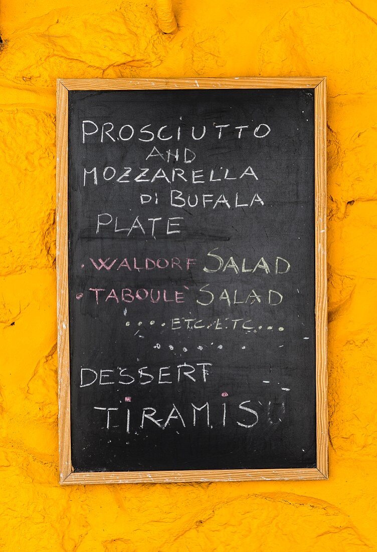 A specials board on a yellow wall