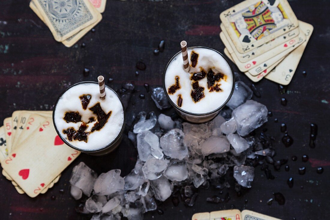 Iced coffee with caramel and playing cards