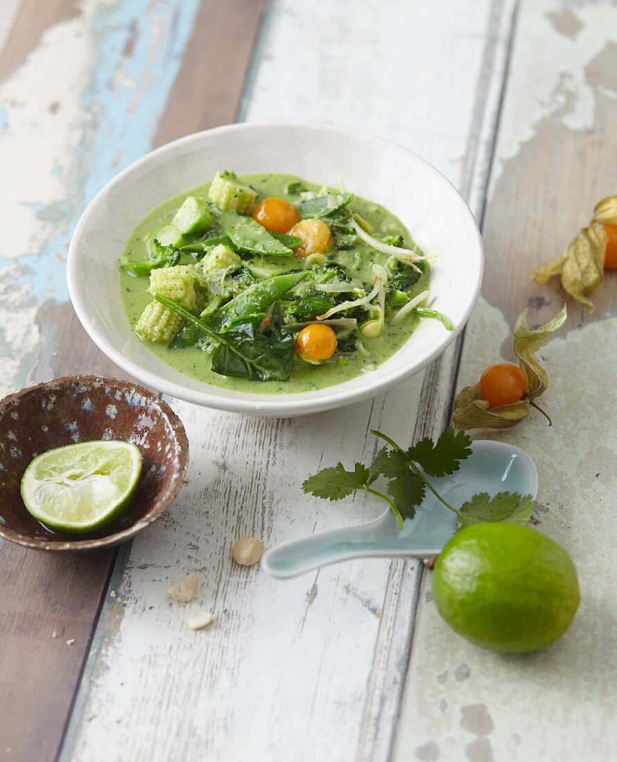 Green Thai curry with coconut milk, baby sweetcorn and physalis