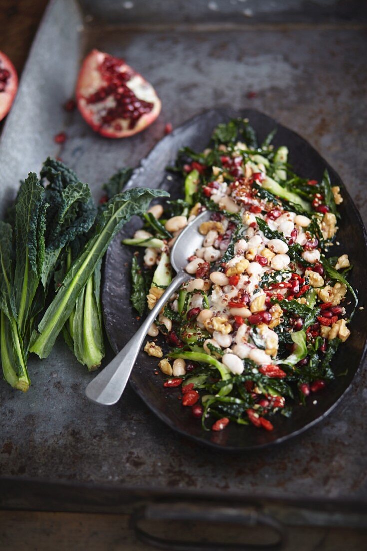Vegan salad with kale, white beans and pomegranate seeds