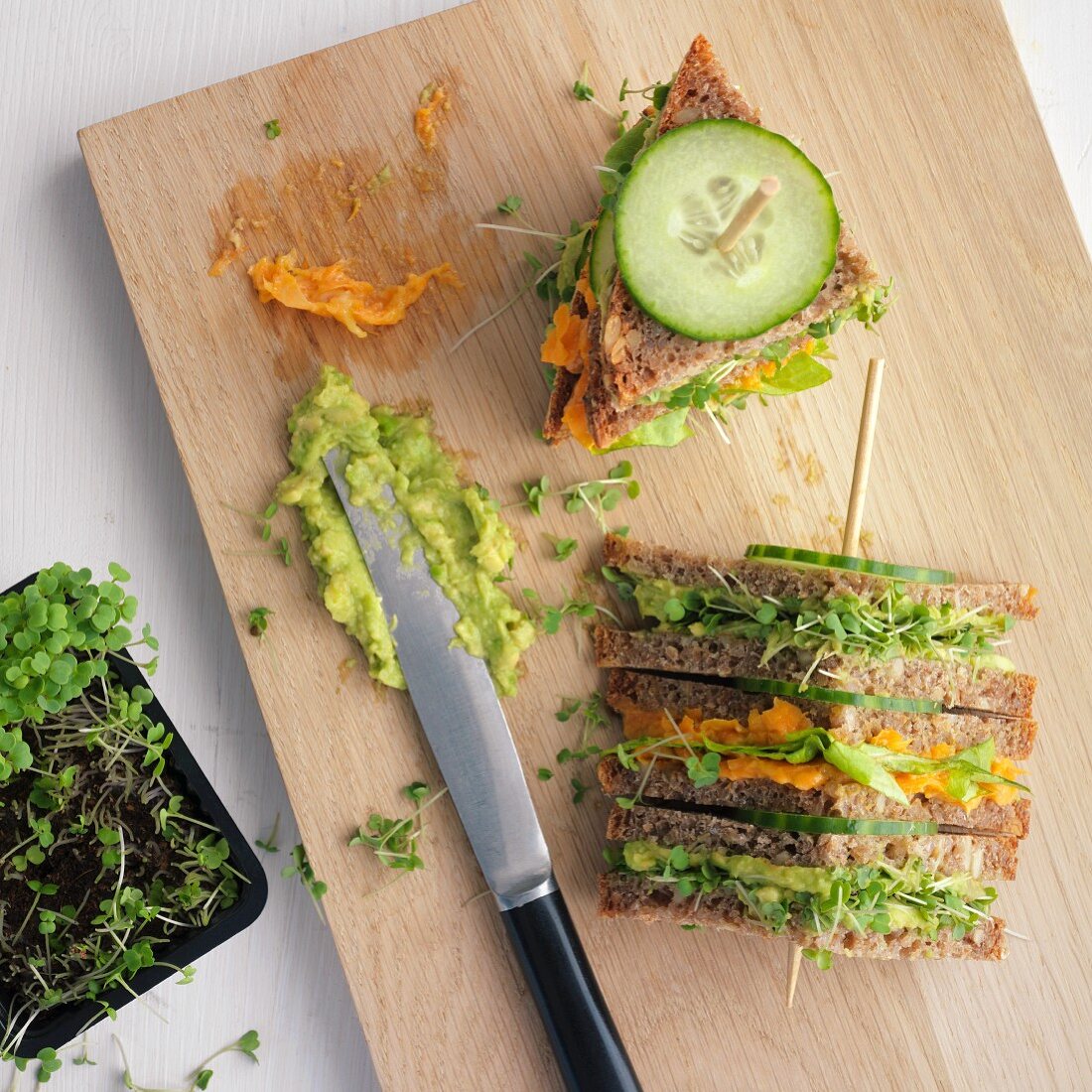 Triangular sandwiches on a sticks with carrots, cucumber, avocado and tahini