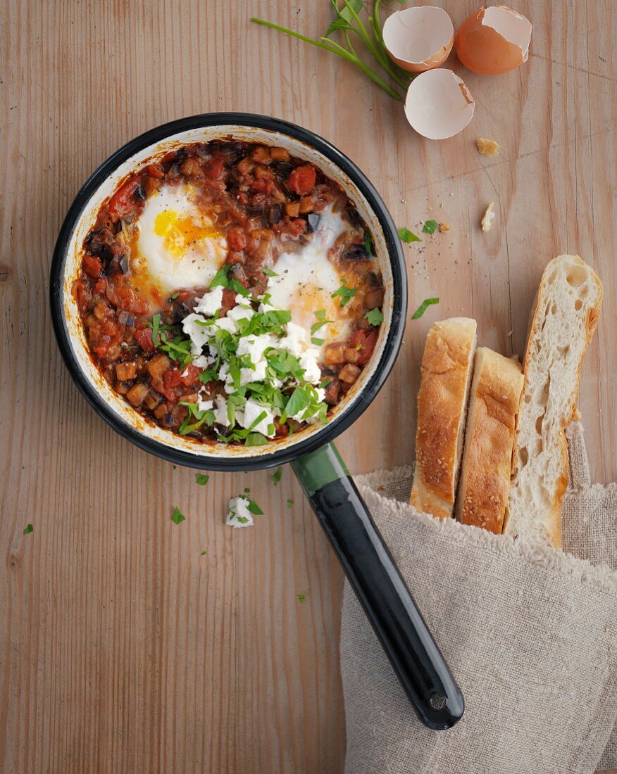 Aubergine shakshuka with poached eggs and unleavened bread