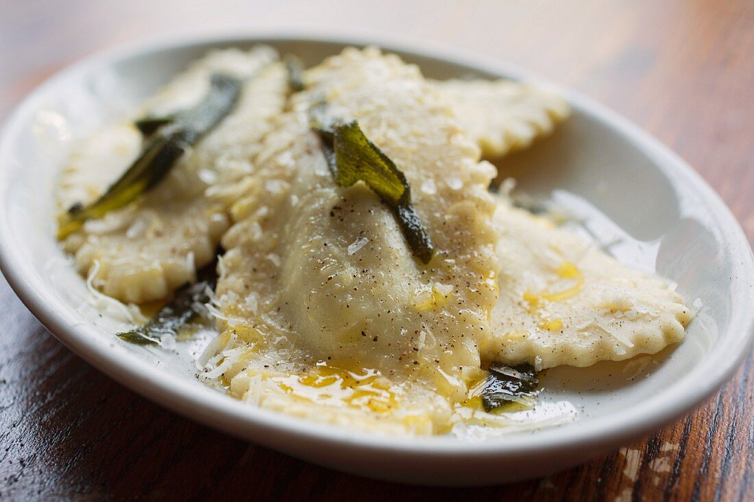 Ricotta-filled ravioli with Parmesan cheese, fried sage and sea salt