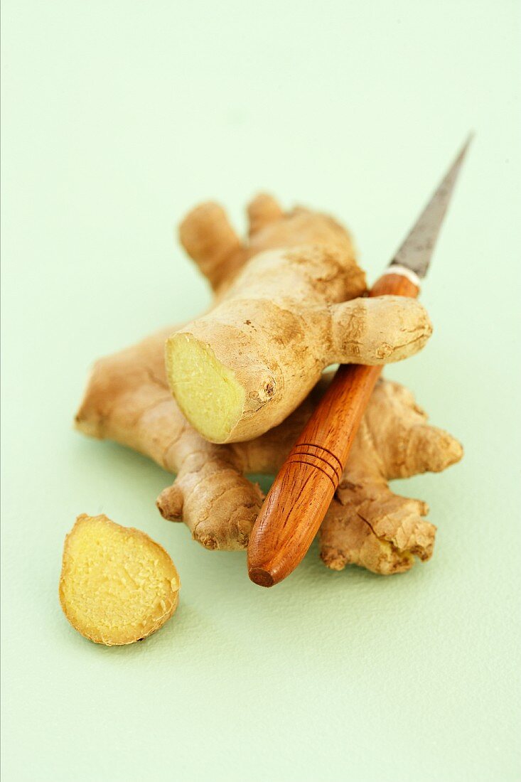 Fresh root ginger with a knife