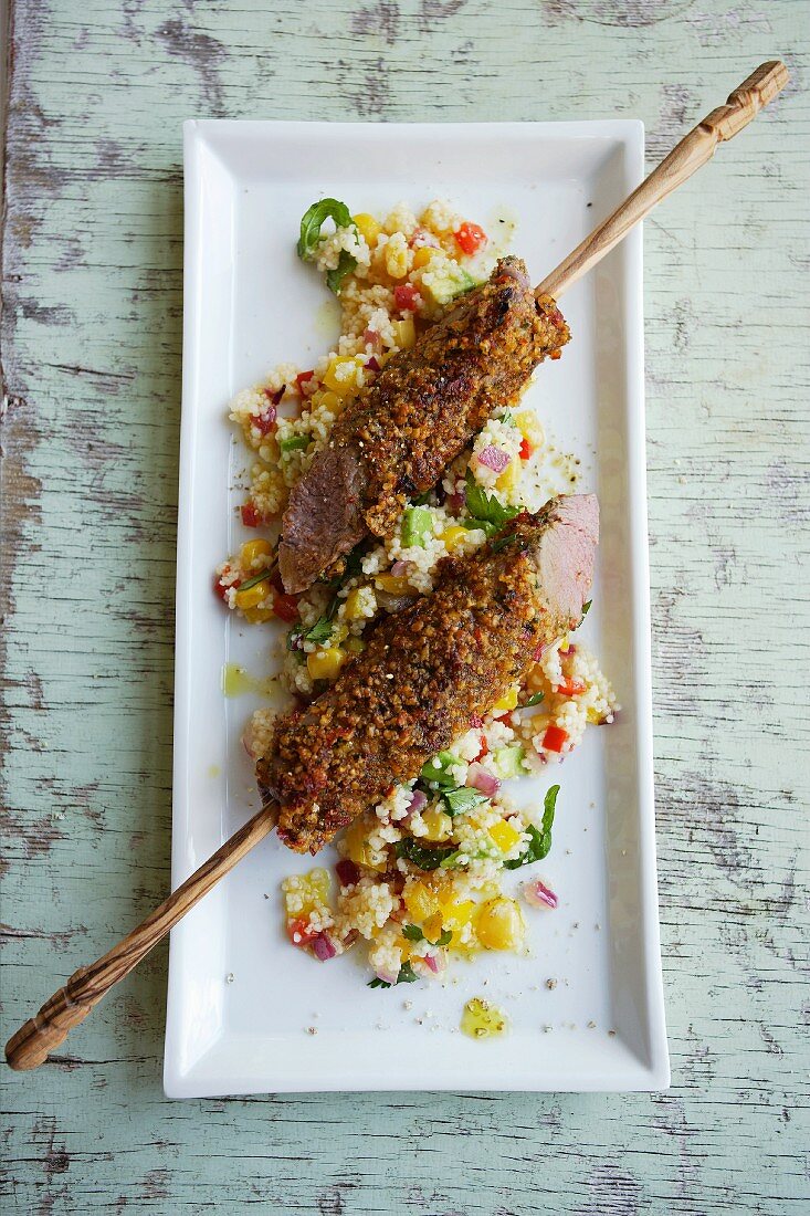 Lamb skewers in a ginger and chilli coating with a warm couscous salad