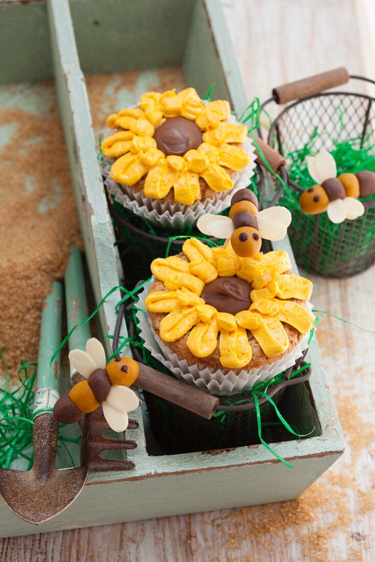Courgette and almond cupcakes decorated with sunflowers and marzipan bees