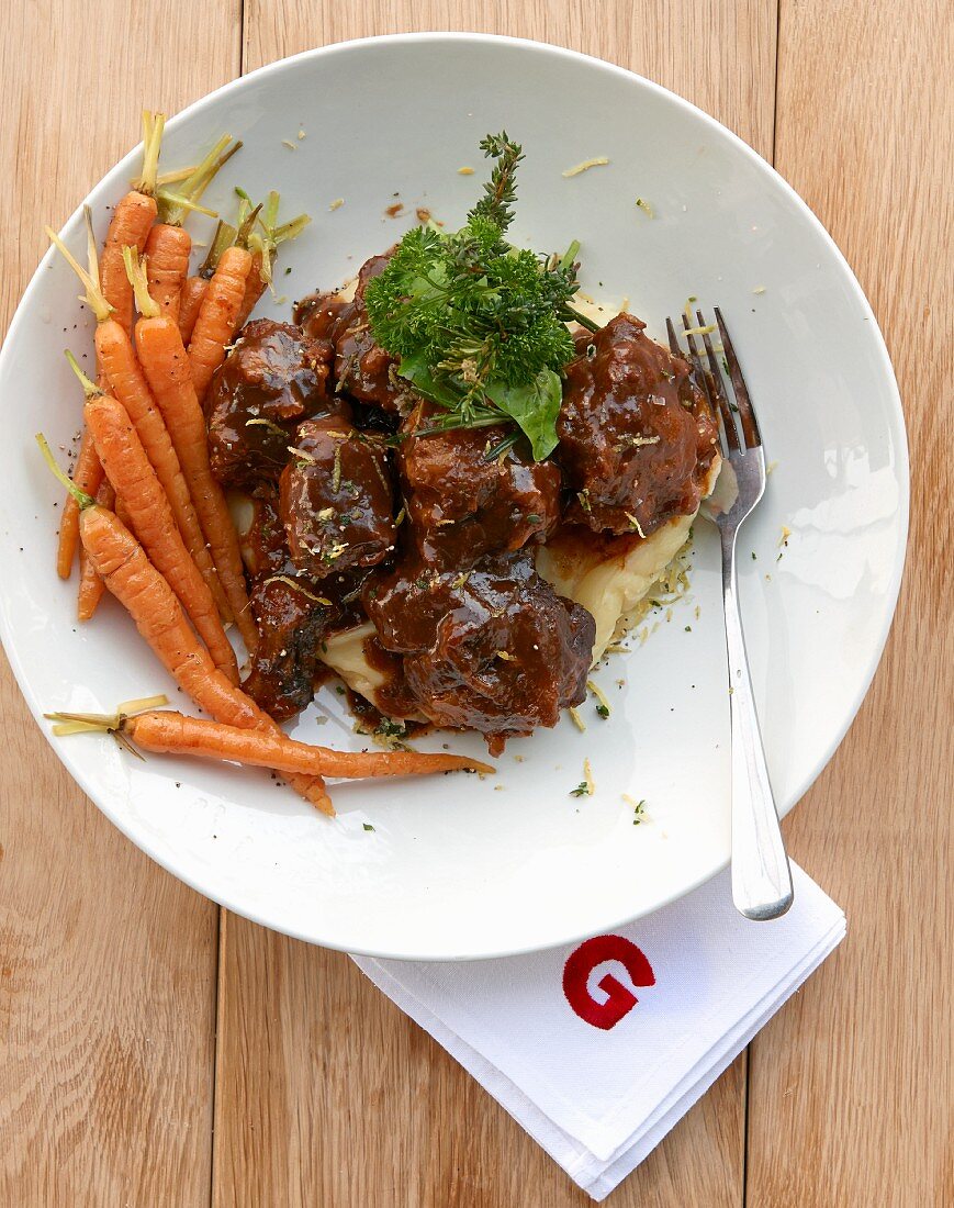Oxtail ragout on mashed potatoes and parsnips with carrots