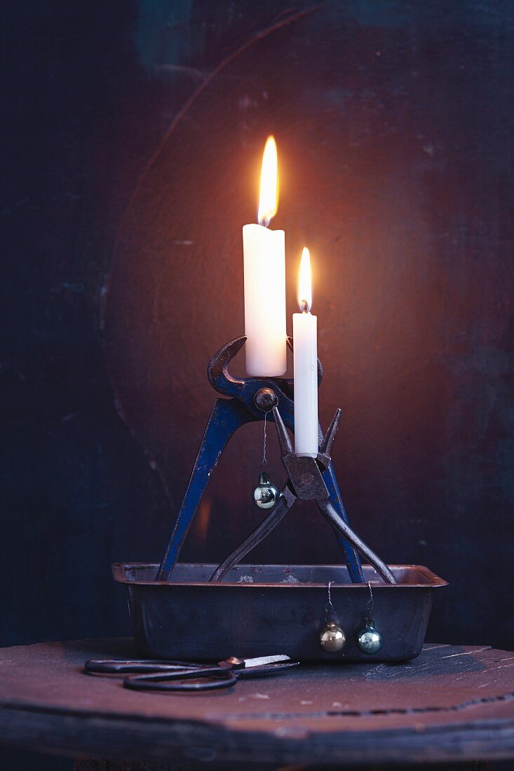 Old pliers being used as candle holders