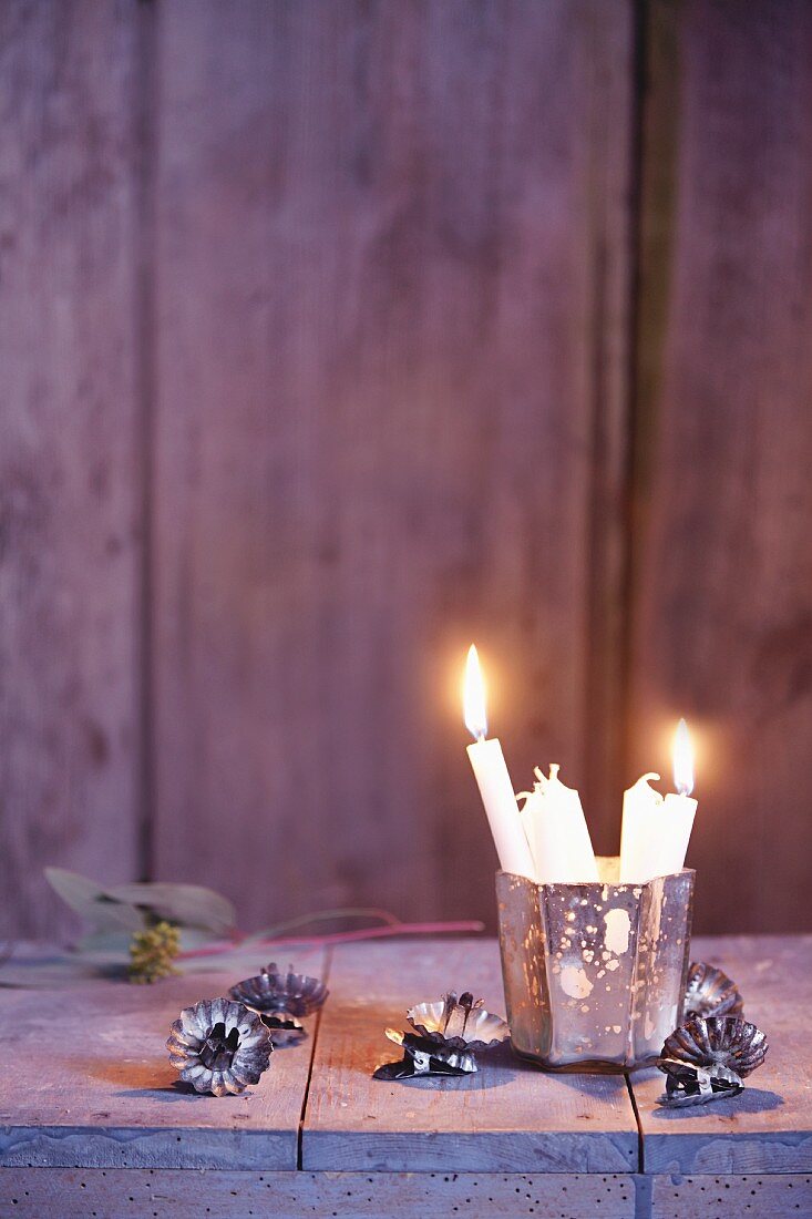 A Christmas tree candle holder and white Christmas tree candles