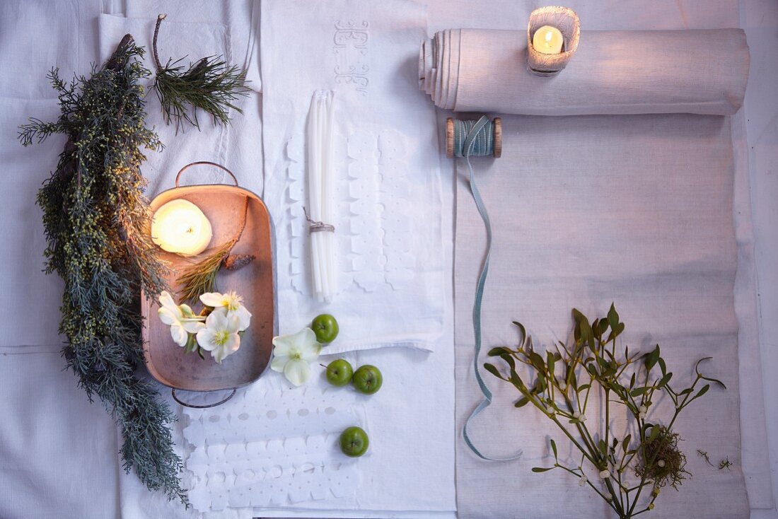 A table laid with natural, winter decorations (seen from above)