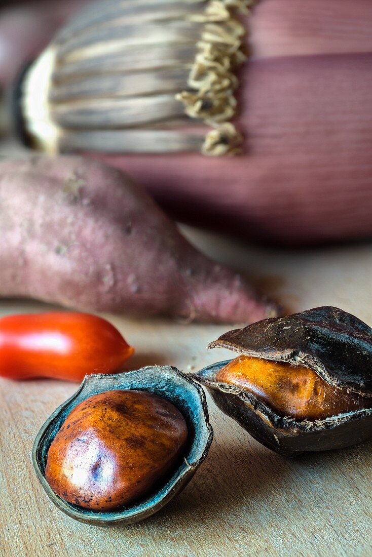 Jengkol fruit, a tomato, a sweet potato and a banana flower