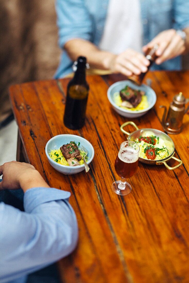 Pork on carrot salad served with beer