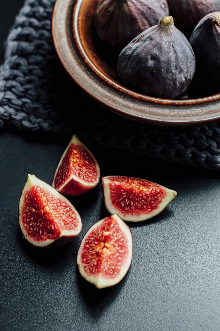 Fresh figs in a ceramic bowl and next to it