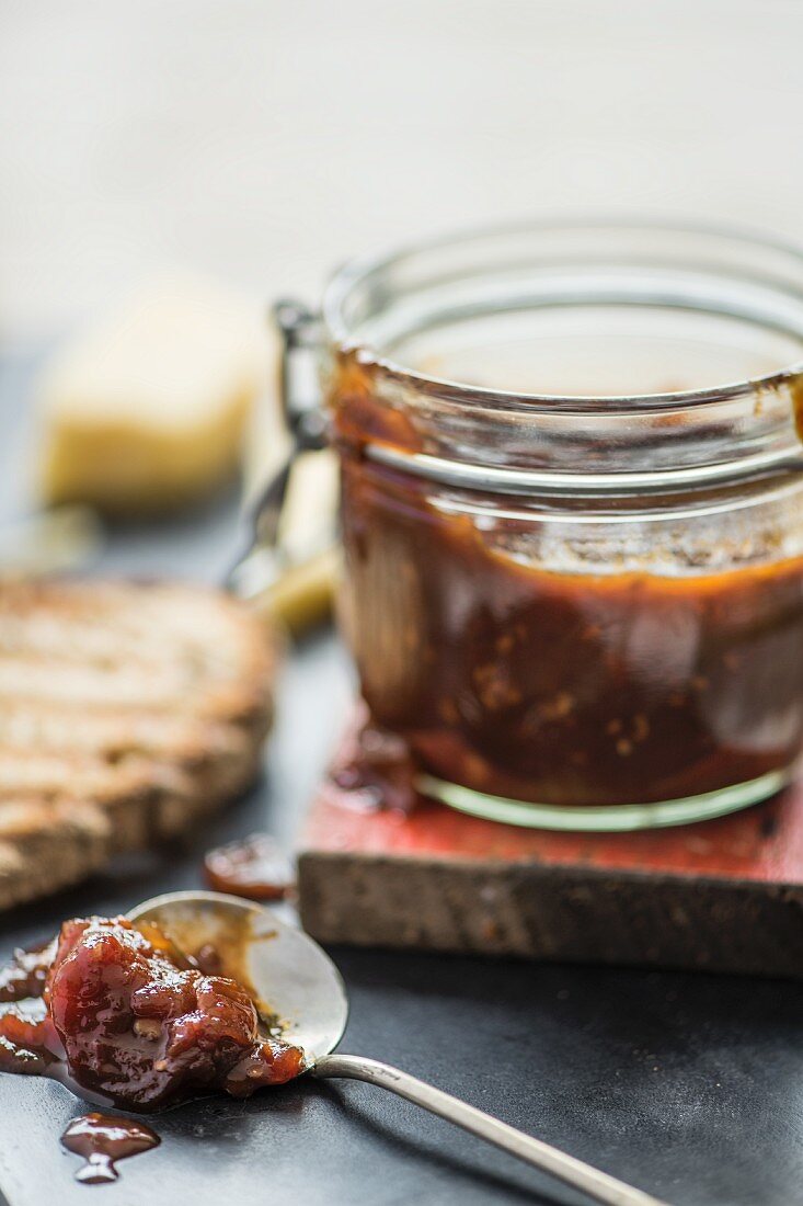 Tomato chutney in a jar and on a spoon