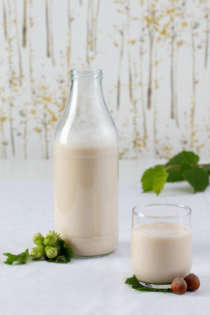 Hazelnut milk and a glass and in a bottle