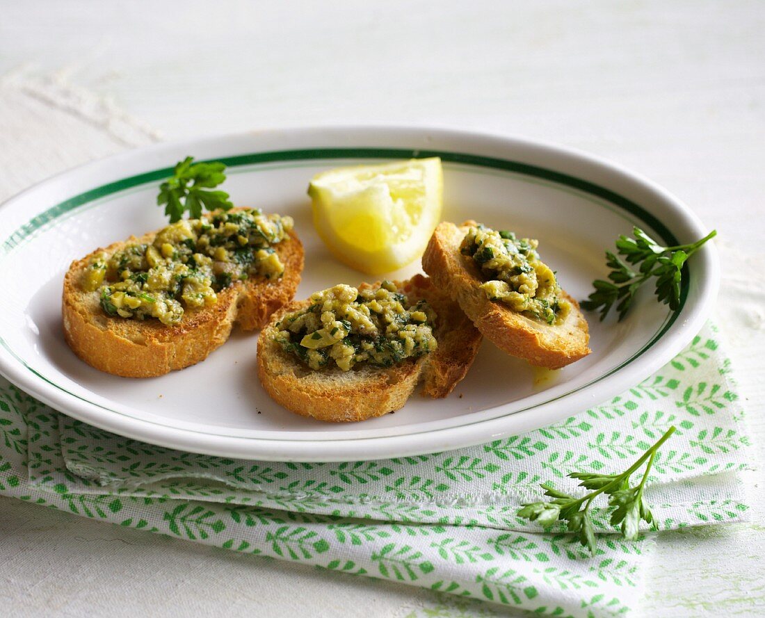 Crostini with green olive and anchovy cream